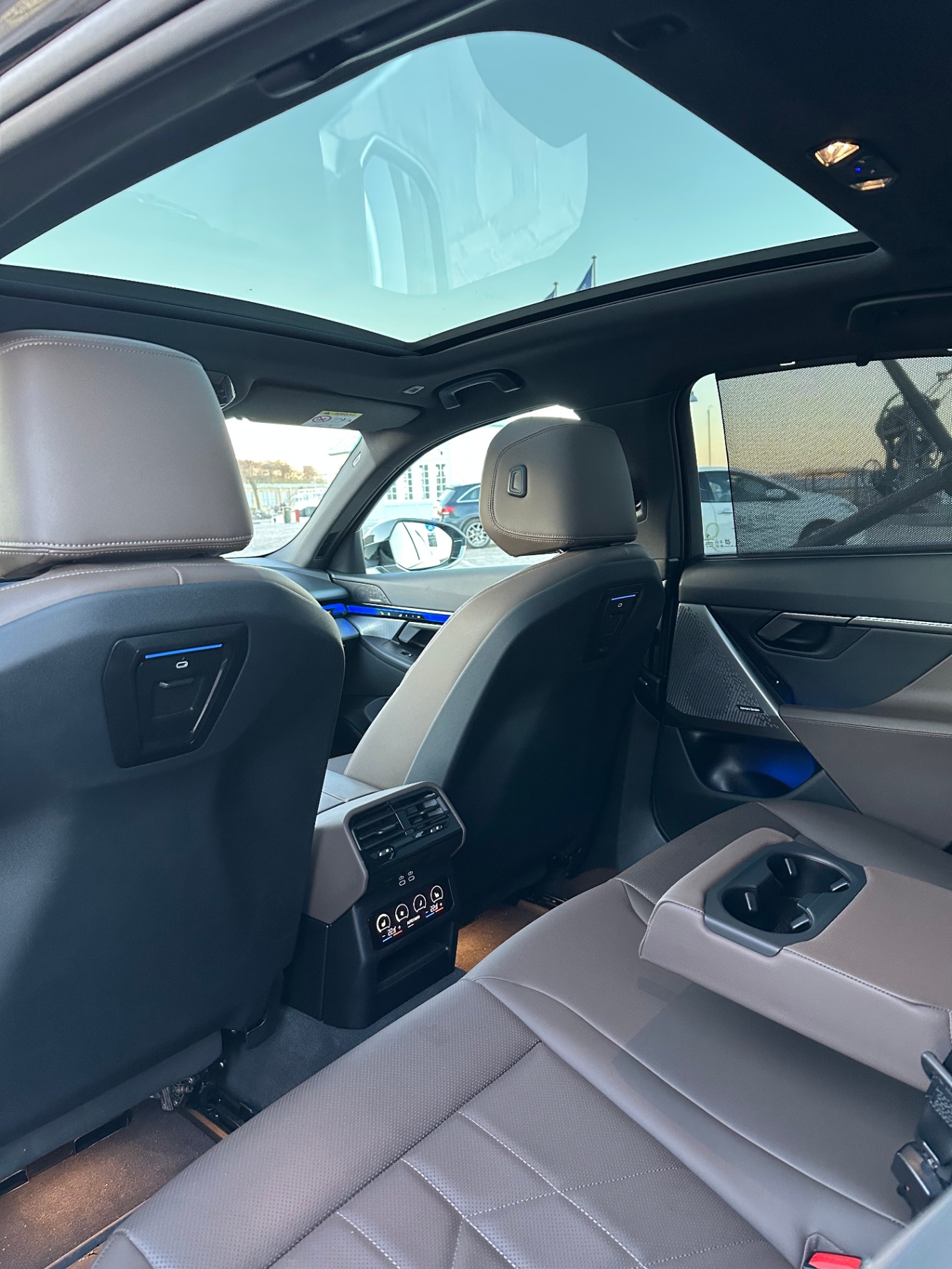 Rear passenger cabin with leather seating and panoramic roof in the BMW i5